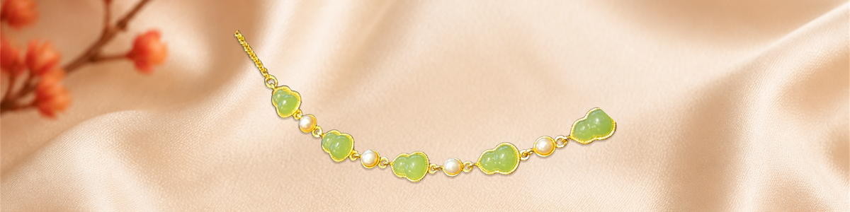 Hetian jade bracelet photographed on champagne silk with red flowers