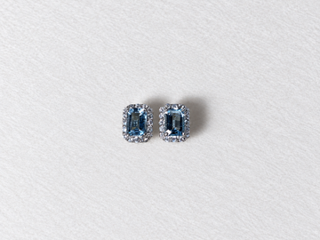 Blue emerald cut gemstone halo silver stud earrings view 1