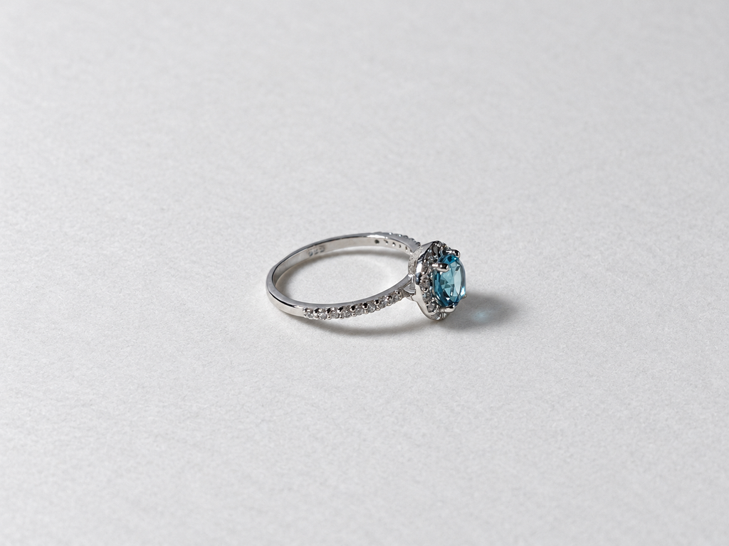 Blue topaz halo silver ring side view