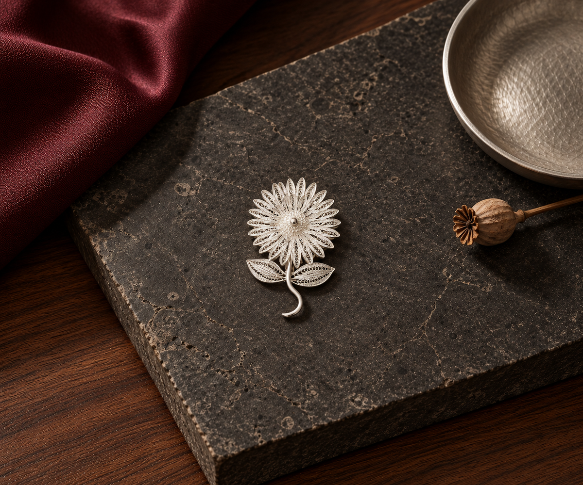 Handcrafted silver floral brooch flat lay