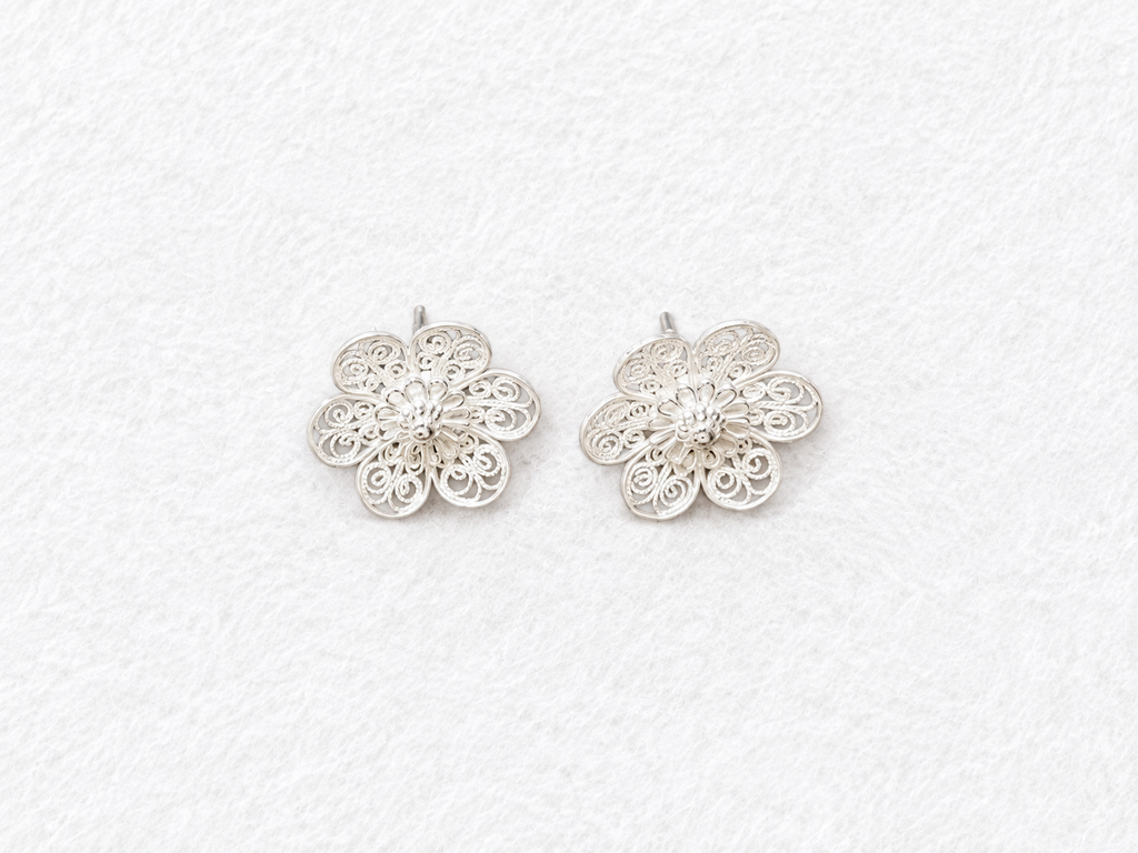 Handcrafted silver filigree floral earrings angled view