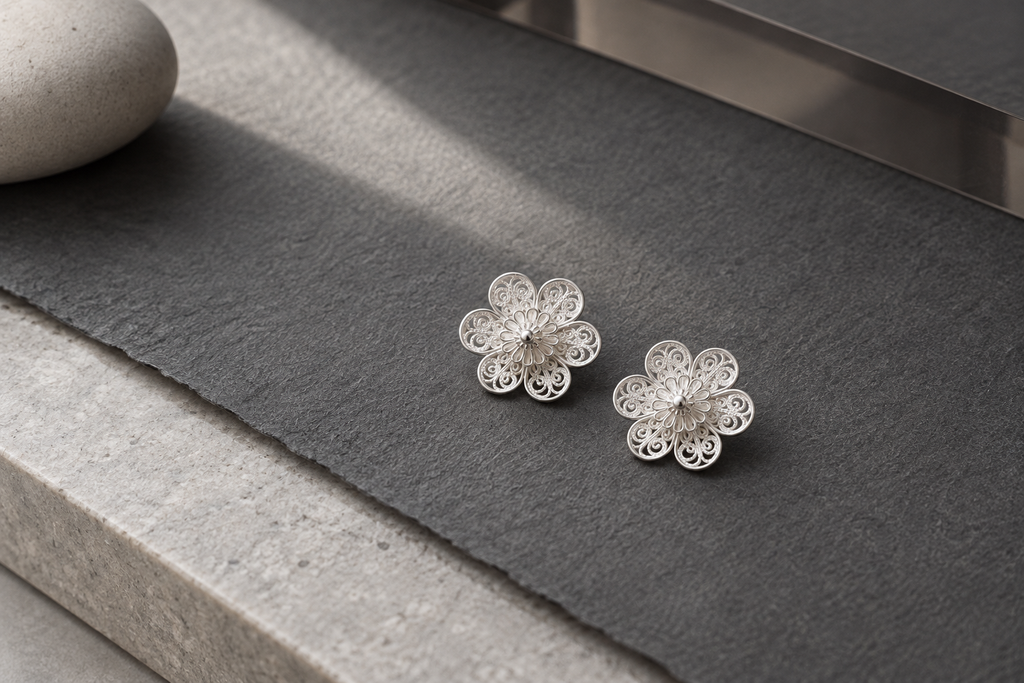 Handcrafted silver filigree earrings flat lay