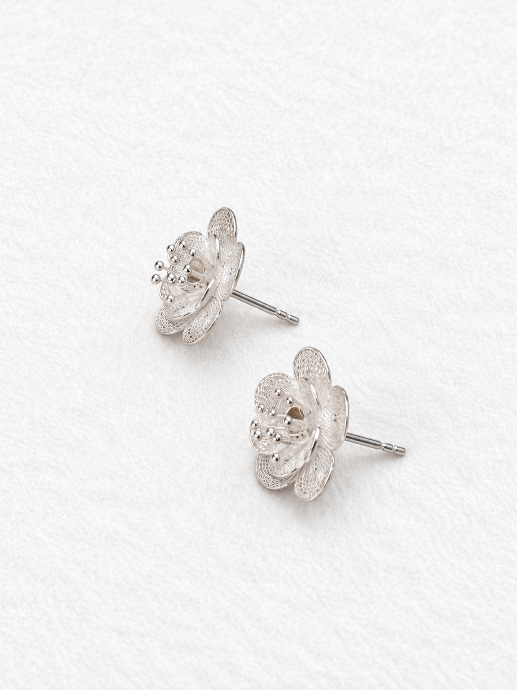Handcrafted silver floral earrings side view