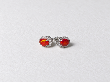 Red oval gemstone halo silver stud earrings view 2