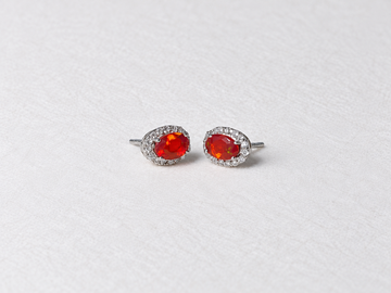 Red oval gemstone halo silver stud earrings view 3